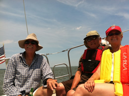 Julie with husband, Jim, and friend Carl Mills sailing in Rehoboth Bay, Delaware