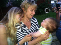 Julie holding her grandson, Nate, with his Aunt Becky (Julie’s youngest daughter)